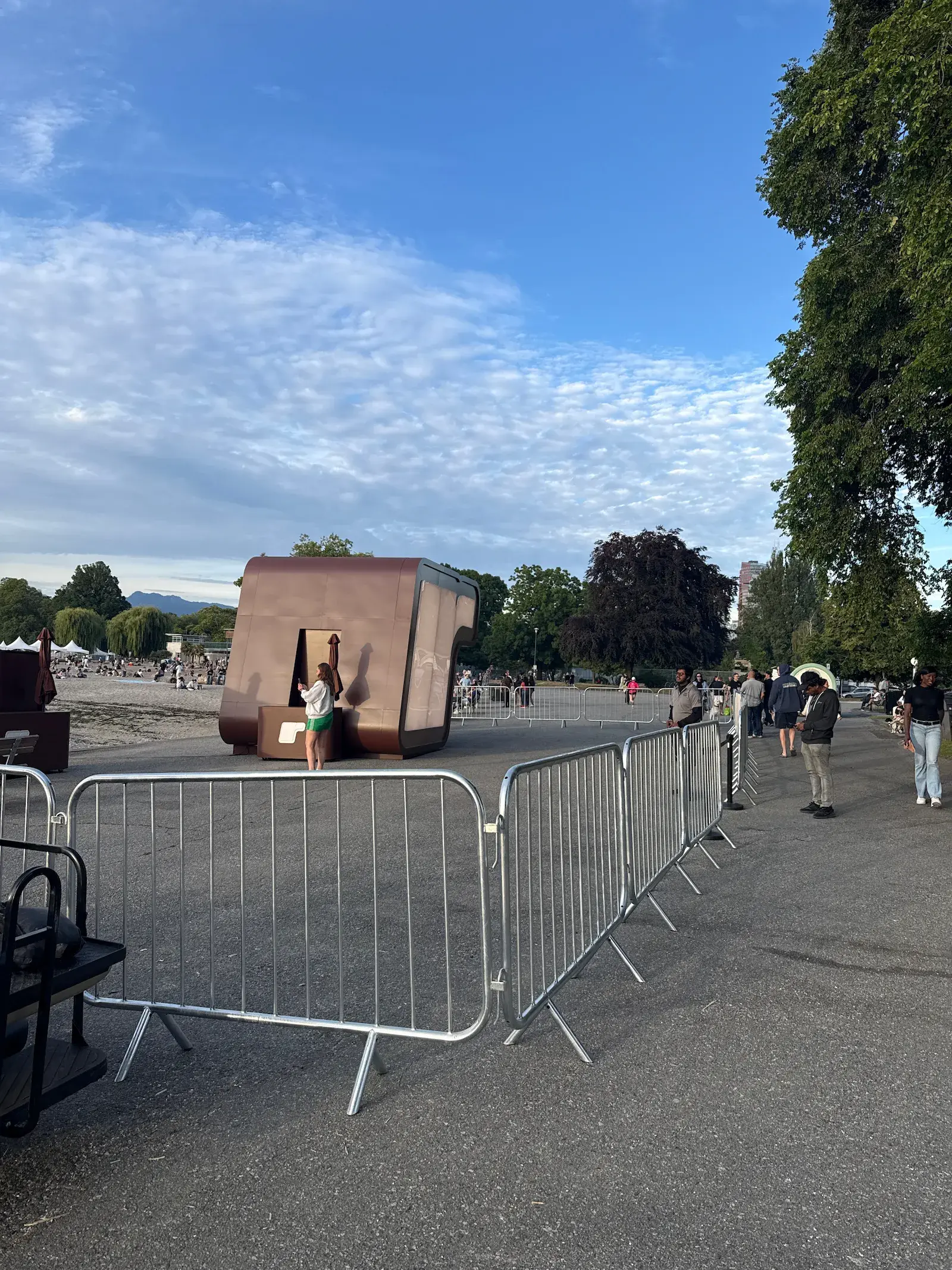 Crowd control barriers lining a path at a waterfront event.