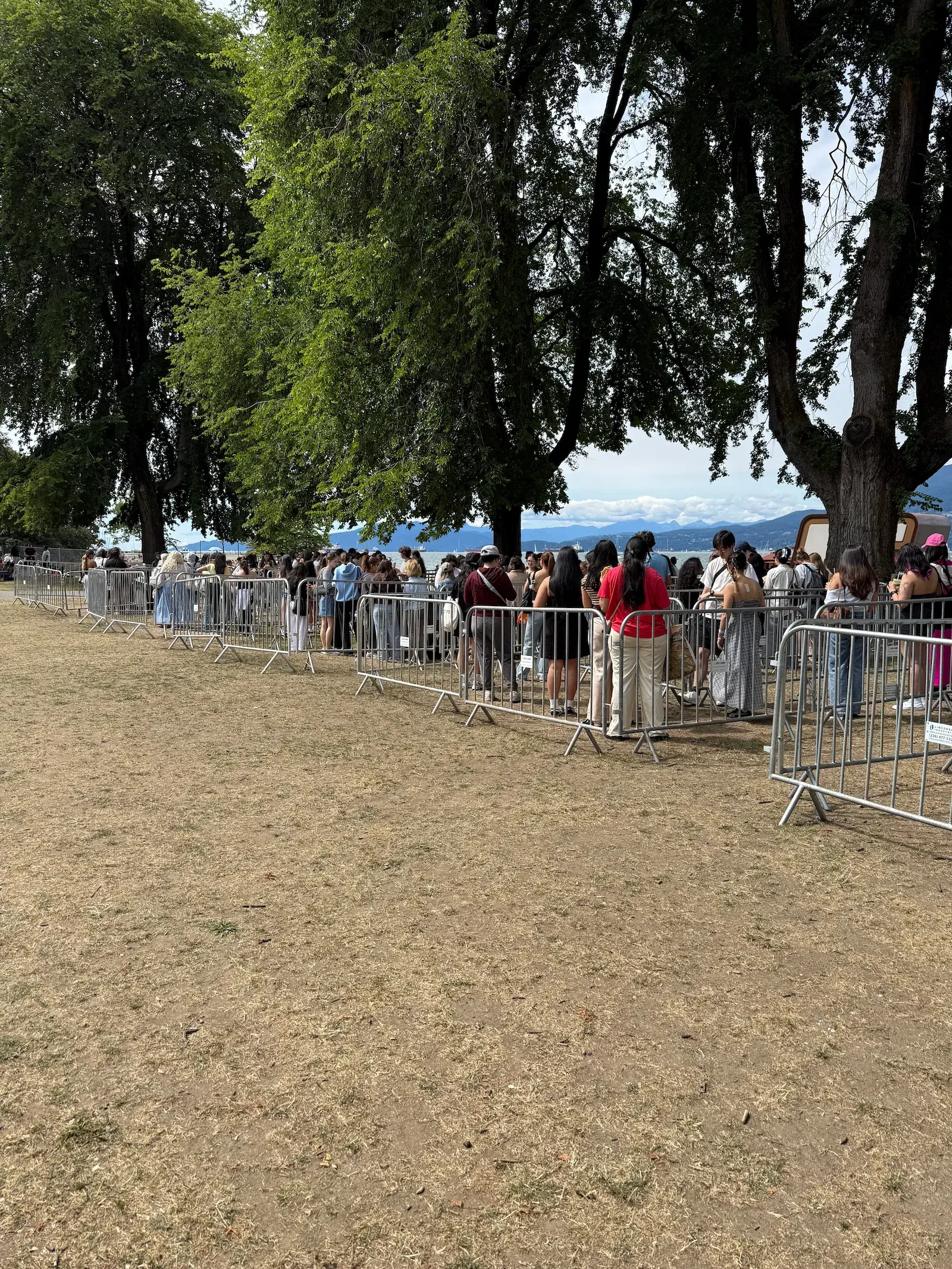 Bike rack style barriers forming a queue line at an outdoor event.