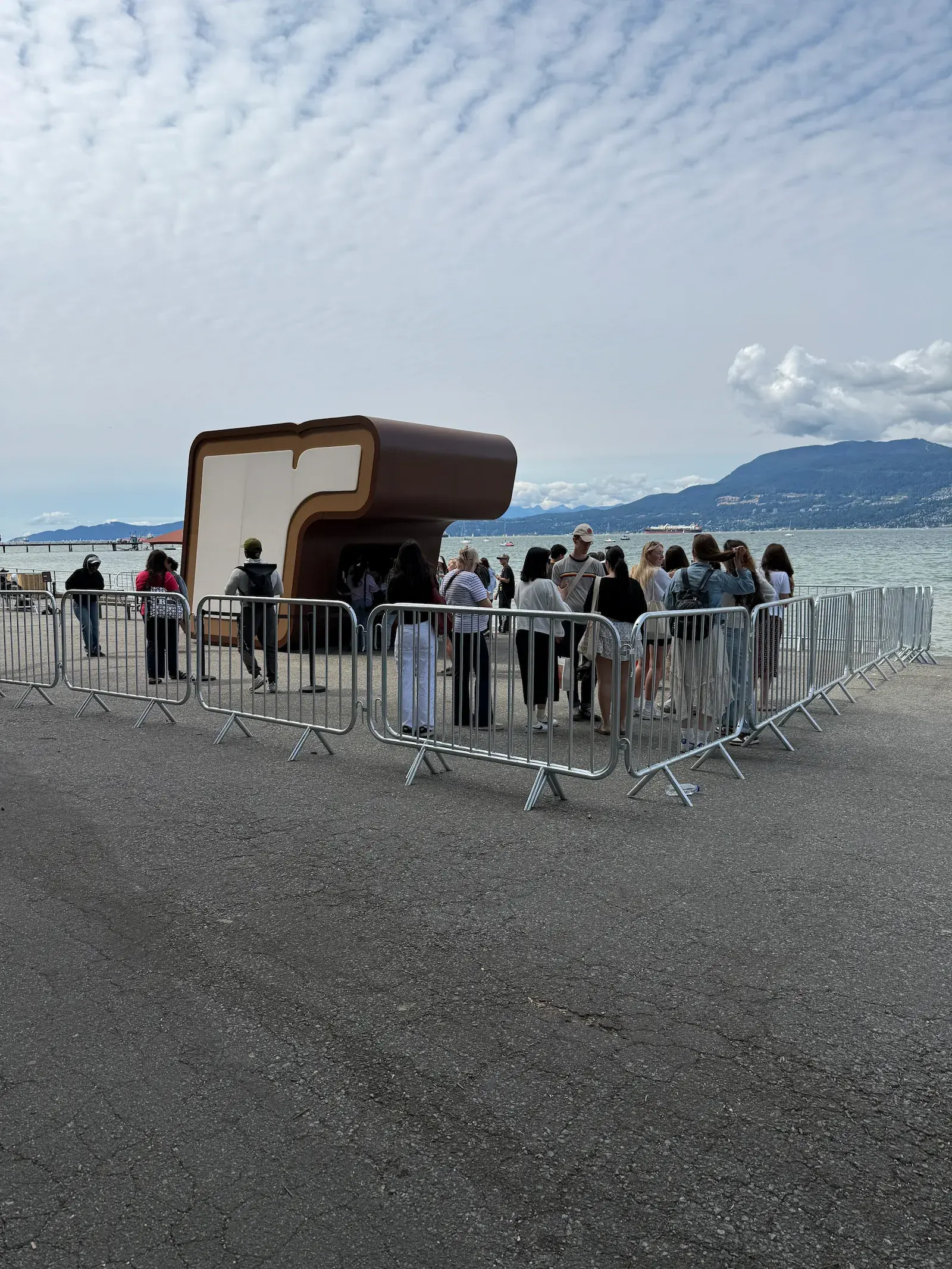 Steel crowd control barriers set up around an outdoor activation.