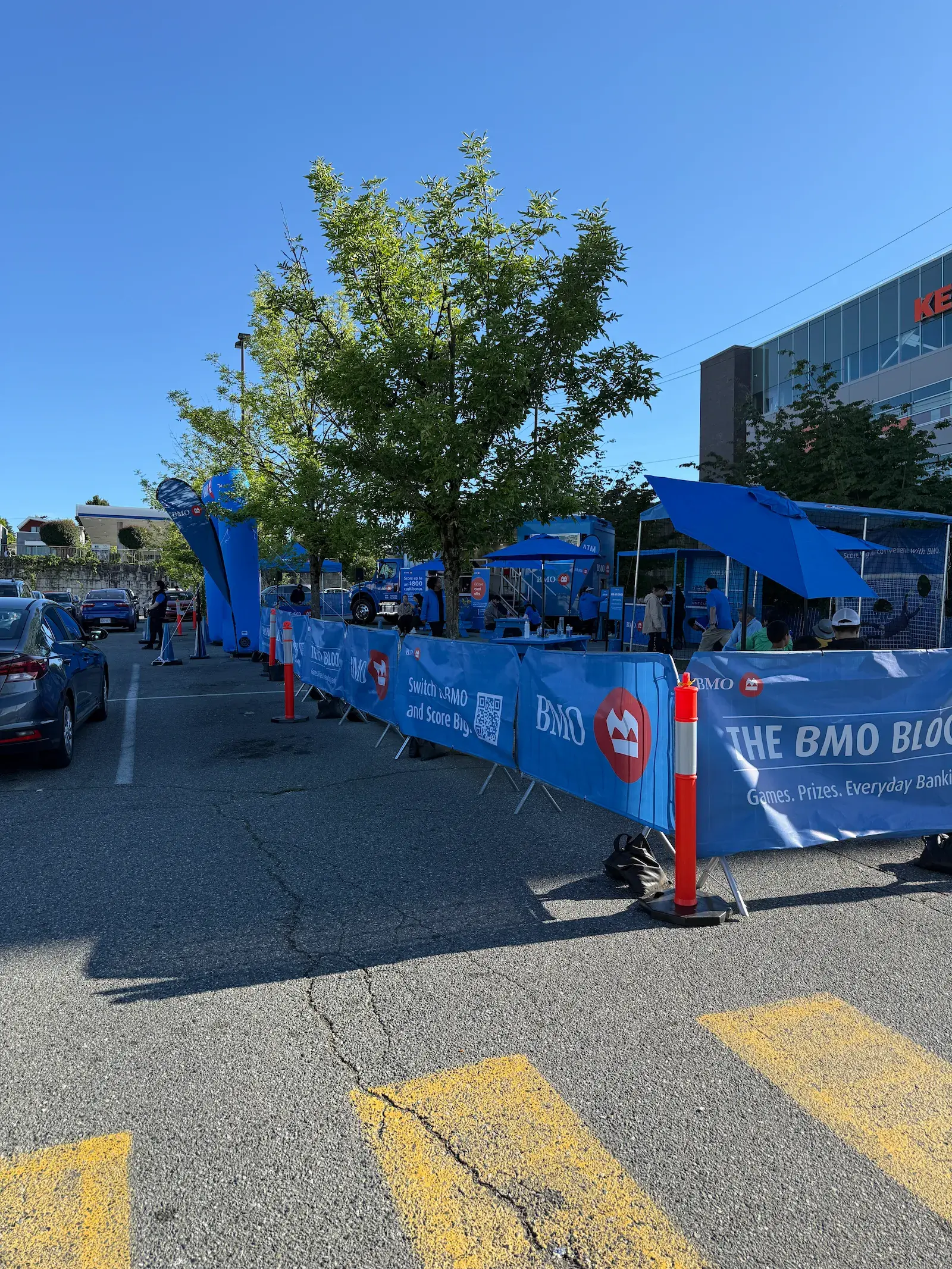 Branded steel barricades lining a parking lot activation.